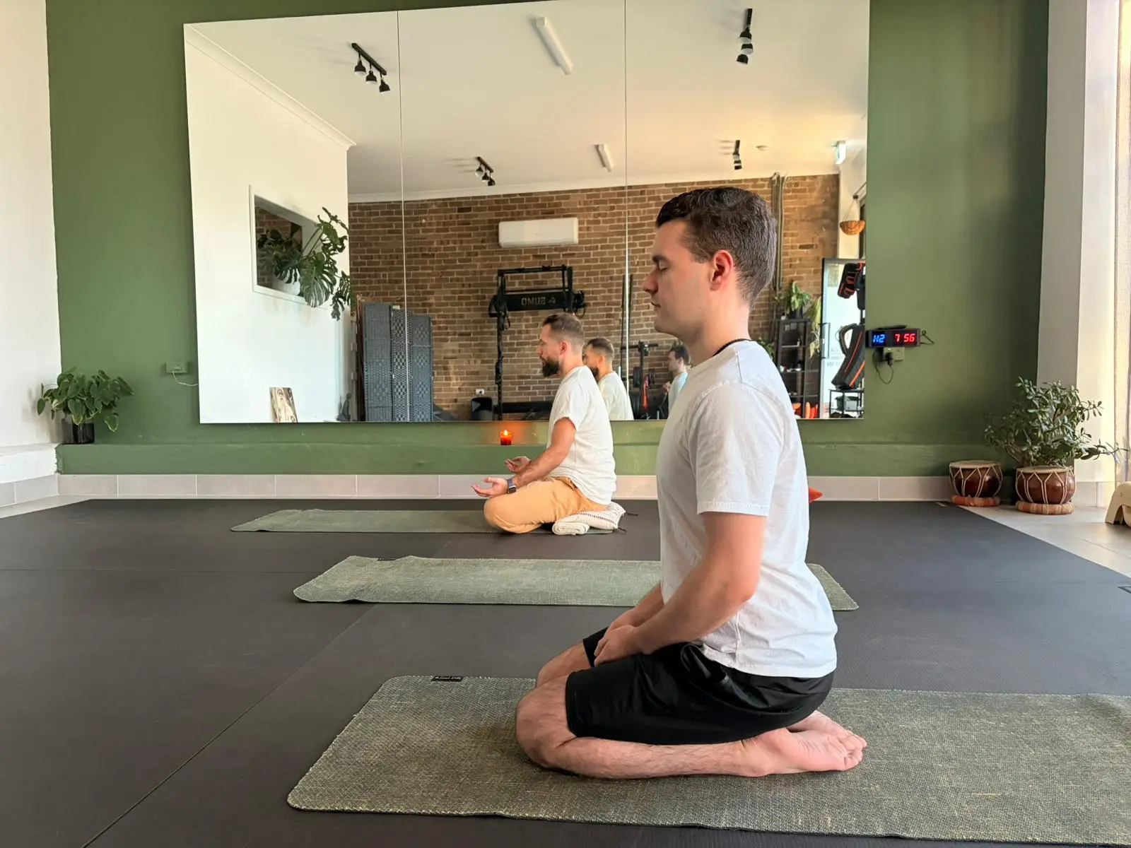 Members in a calm seated meditation at the Adiyoga studio in Earlwood, Sydney